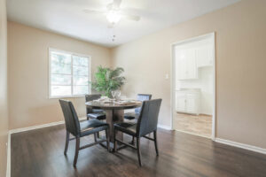 bright dining room with dark hardwood flooring