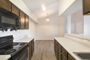 interior unit kitchen, linoleum countertops, black appliances, dining area nea fouyer.