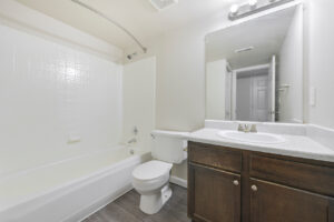 Interior Unit Bathroom, dark brown cabinetry, linoleum countertop, bathtub/shower.